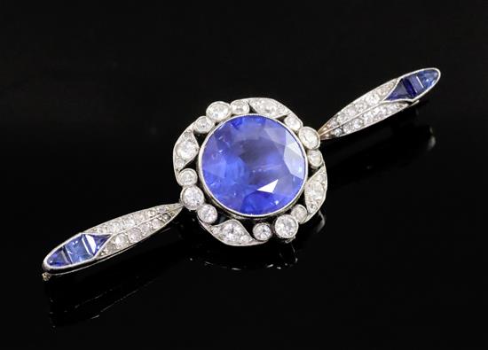 A sapphire and diamond bar brooch, the central round-cut sapphire with diamond border, flanked by marquise-set diamonds and sapphires